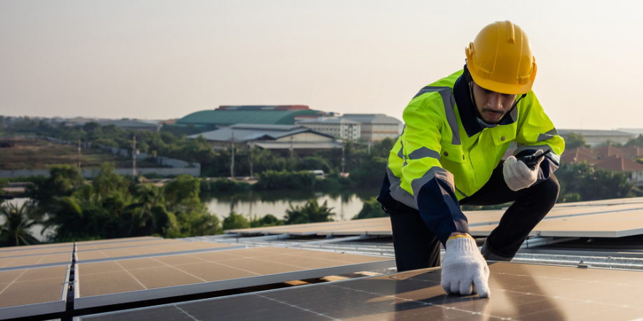 Man on a roof inspecting Solar Panels