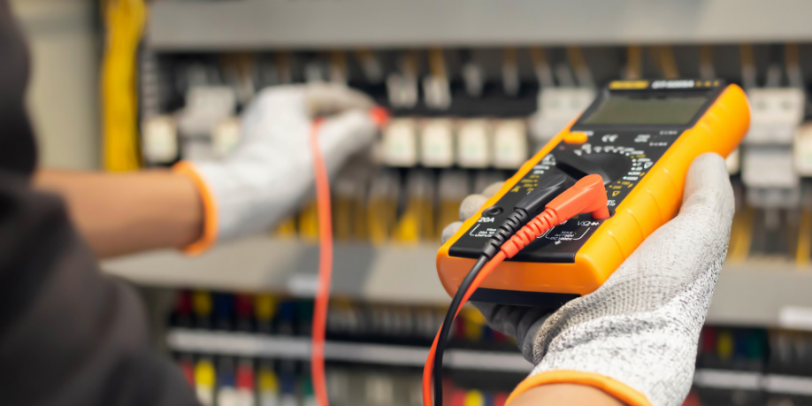 Technician performing maintenance on an electrical system